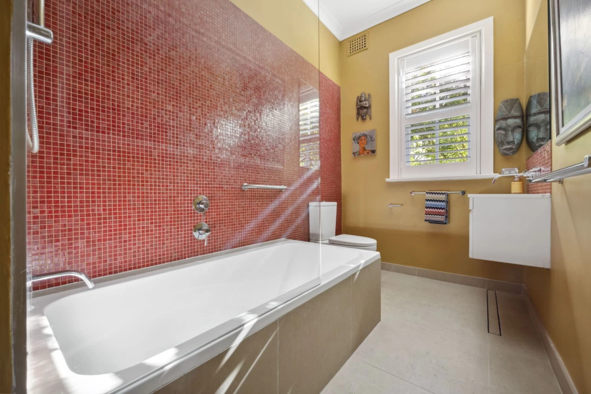 Bathroom with a big bathtub and vibrant red tiles - 1/7 Lang Street, Mosman NSW 2088