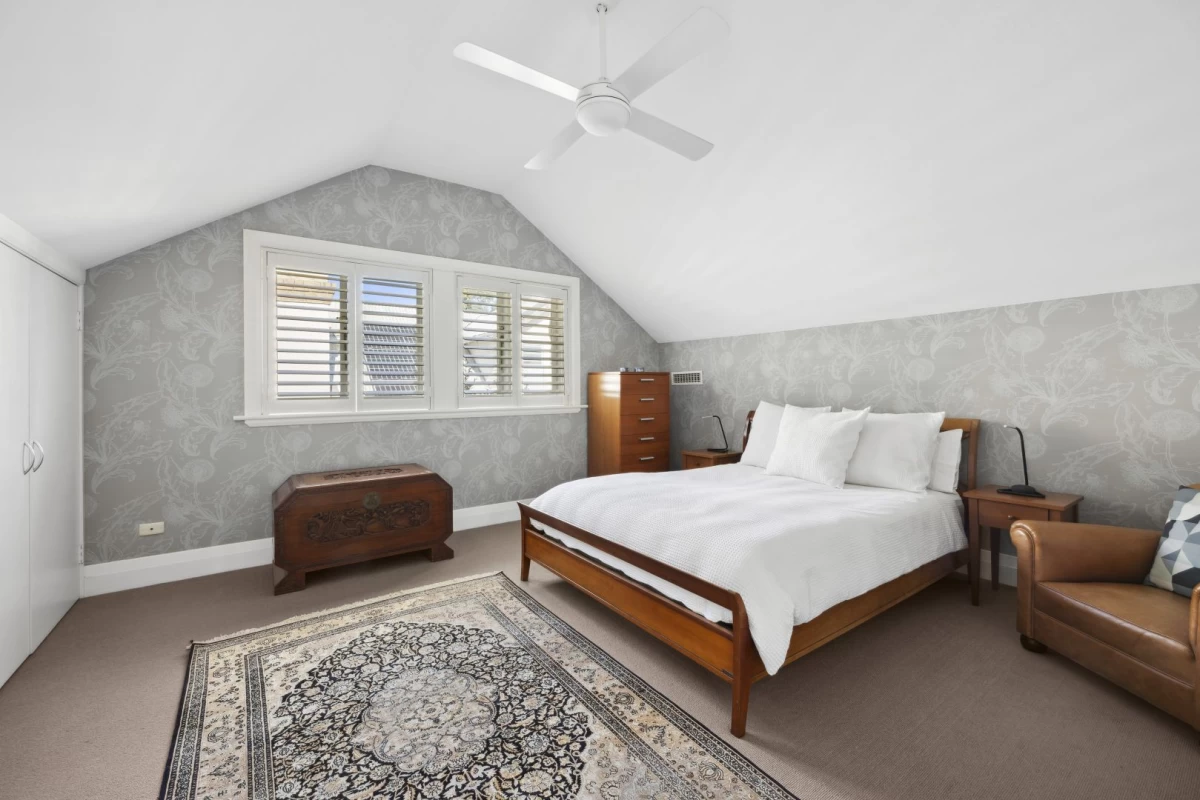 Spacious main bedroom with an angled ceiling and large window - 1/7 Lang Street, Mosman NSW 2088