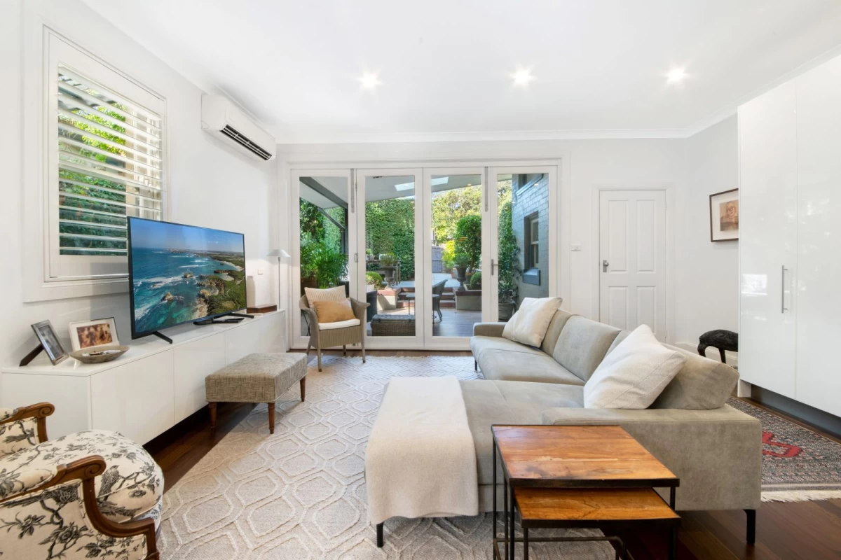 Cosy living room with big windows and glass doors leading outside. - 127 Avenue Road, Mosman, NSW 2088