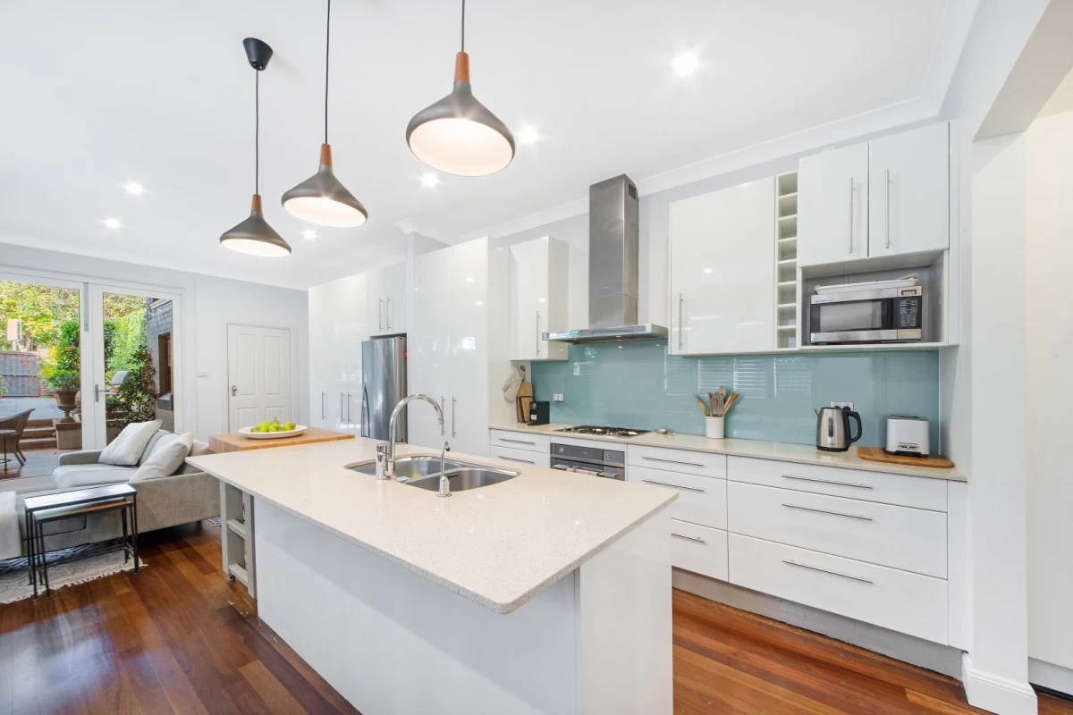 Modern kitchen with ample counter space and storage, ideal for social cooking. - 127 Avenue Road, Mosman, NSW 2088