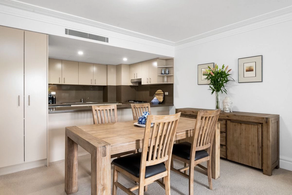 Open dining and kitchen area with ample storage and modern appliances - 18/1A Bond Street, Mosman, NSW 2088