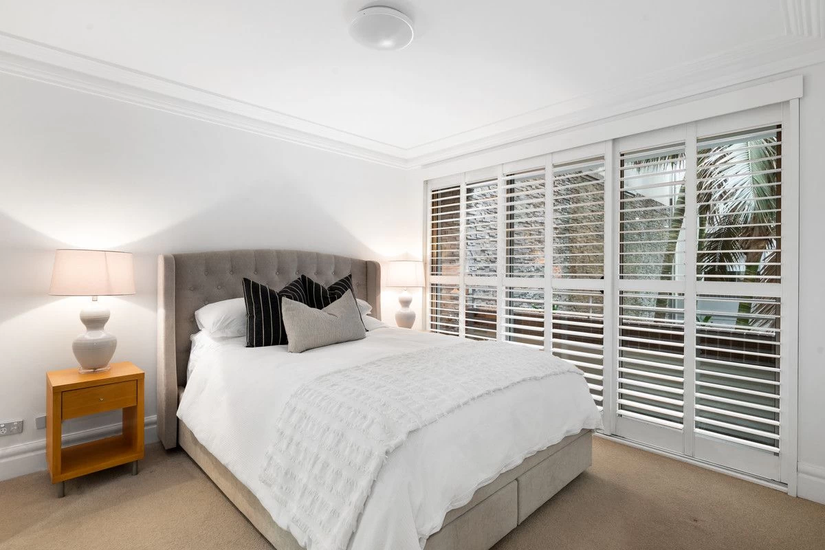 A well-lit bedroom with large windows and a comfortable space - 18/1A Bond Street, Mosman, NSW 2088