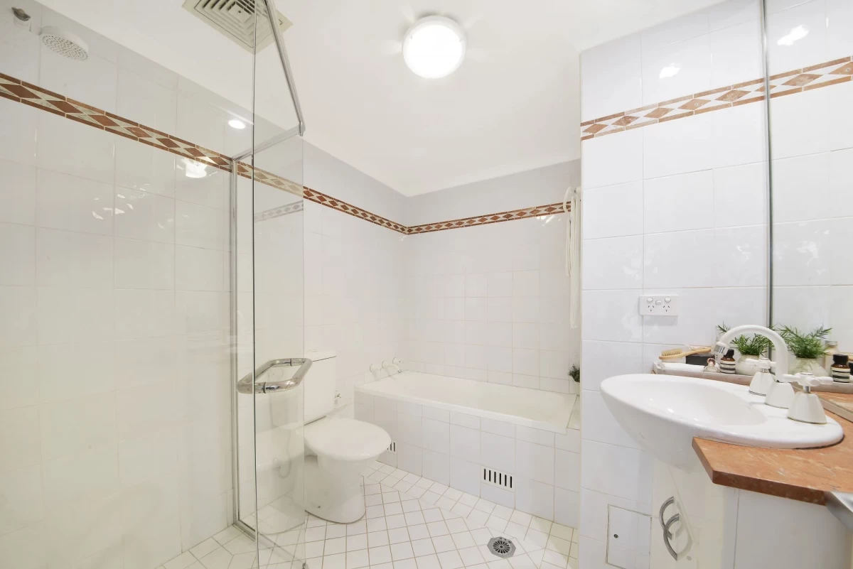 Practical bathroom with a bathtub, separate shower, and clean white tiles - 18/69 Bradleys Head Road, Mosman, NSW 2088