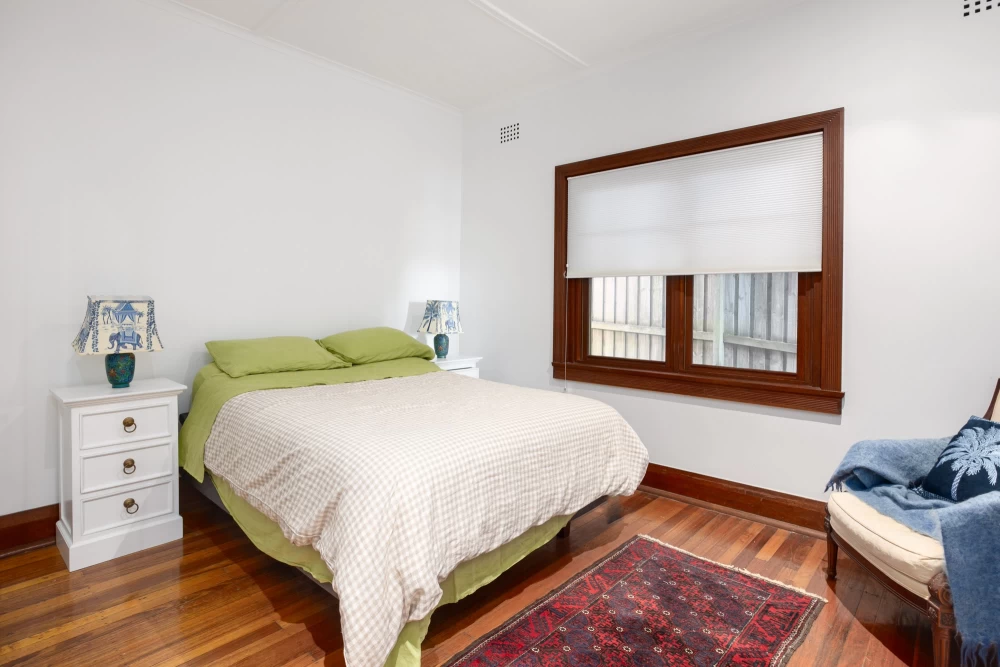 A bright bedroom with wooden floors and large window - 215A Spit Road, Mosman, NSW 2088