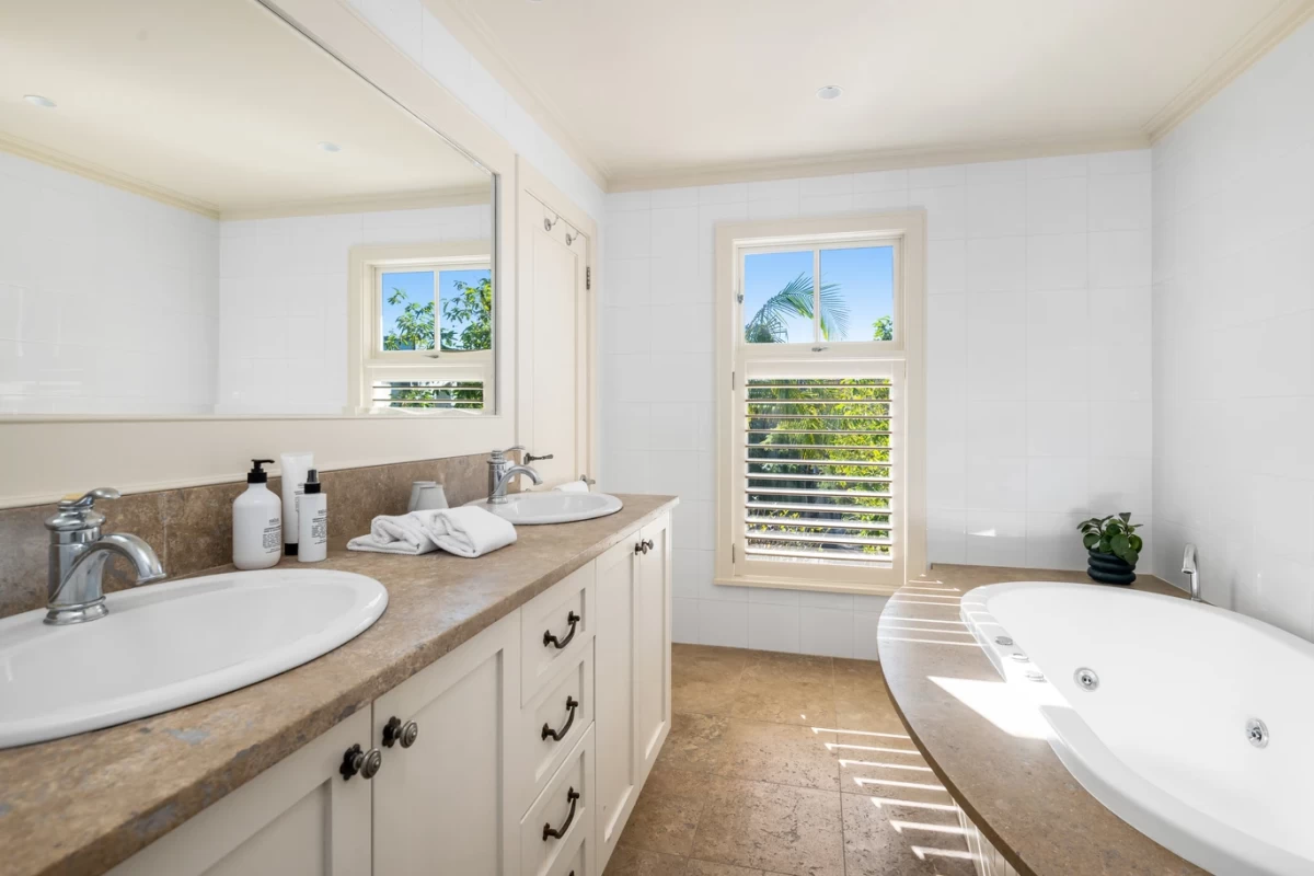 Spacious bathroom with double sink and bathtub, brightened by natural light - 30 Lower Almora Street, Mosman, NSW 2088