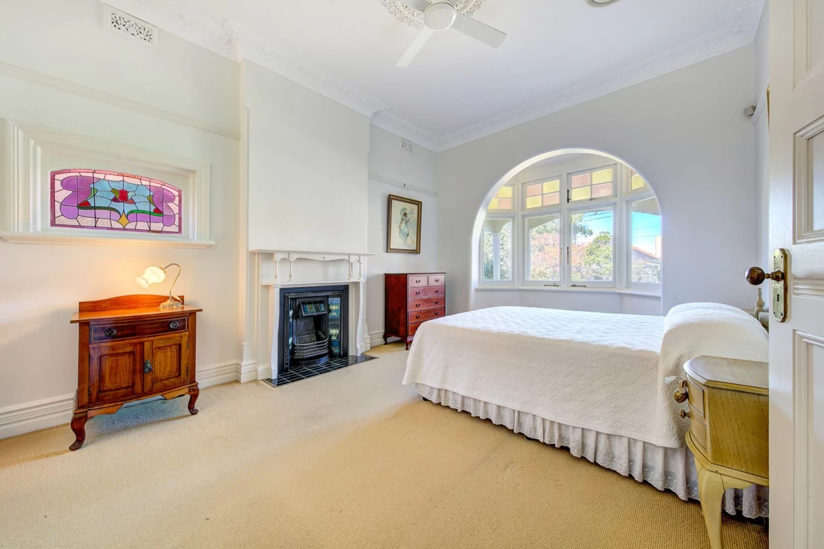 Spacious bedroom with carpet, large window, and a fireplace - 39 Cabramatta Road, Mosman, NSW 2088