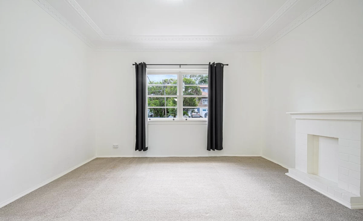 Bright living room with a large window and non-functional fireplace - 4 Morrice Street, Lane Cove, NSW 2066