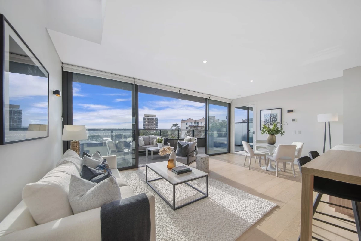 Open living and dining area with large windows and balcony access - 401/116 Belmont Road, Mosman, NSW 2088