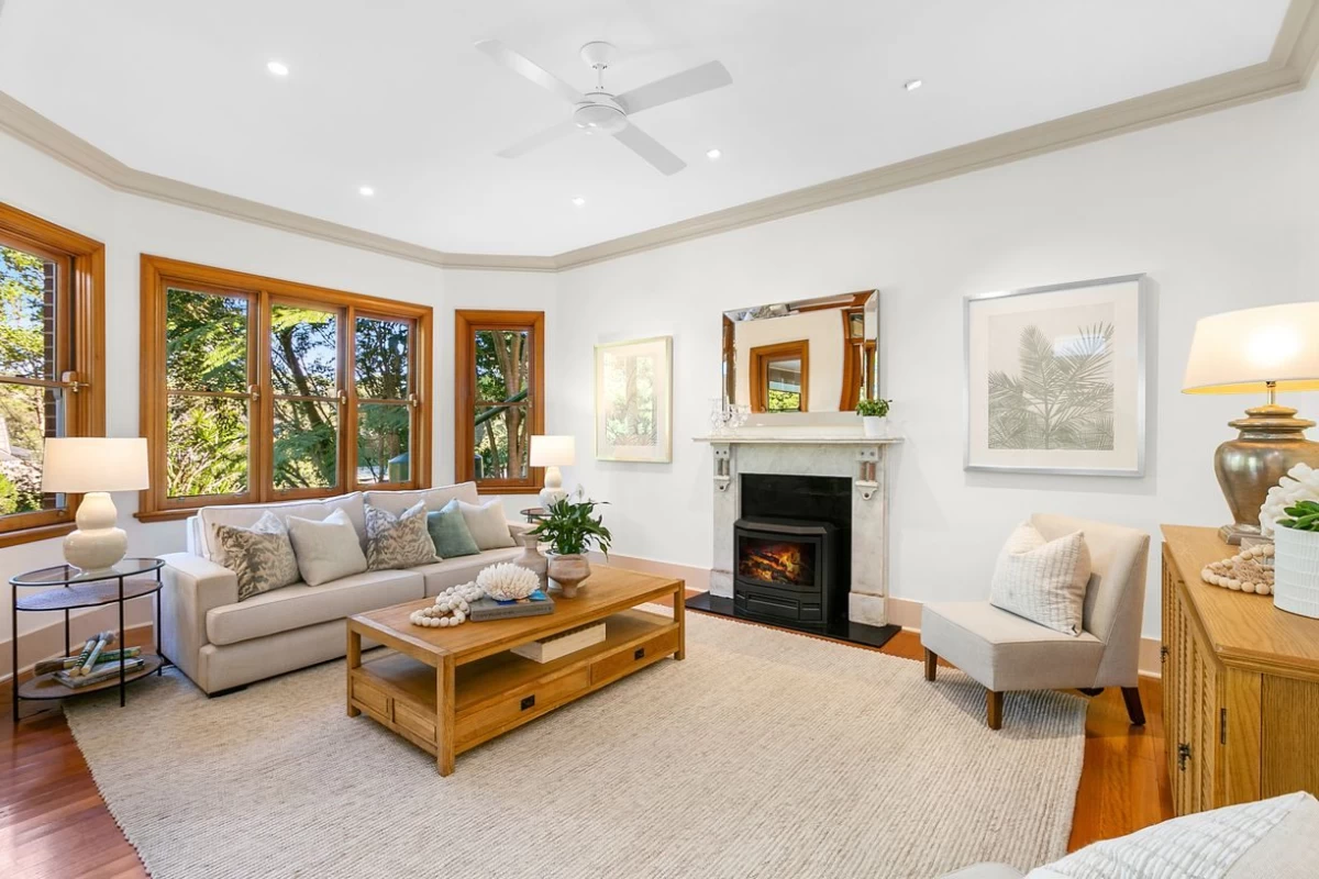 Bright living room with large windows and a cosy fireplace - 47 Kimberley Avenue, Lane Cove, NSW 2066