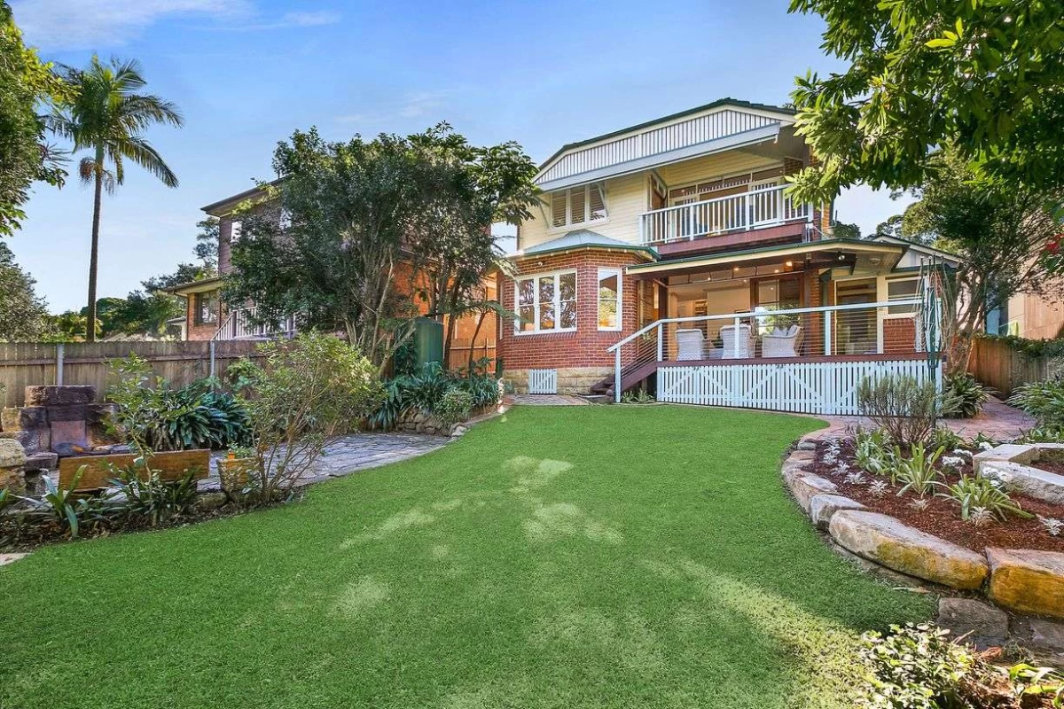 Spacious backyard with grass, plants, and a paved area for activities - 47 Kimberley Avenue, Lane Cove, NSW 2066