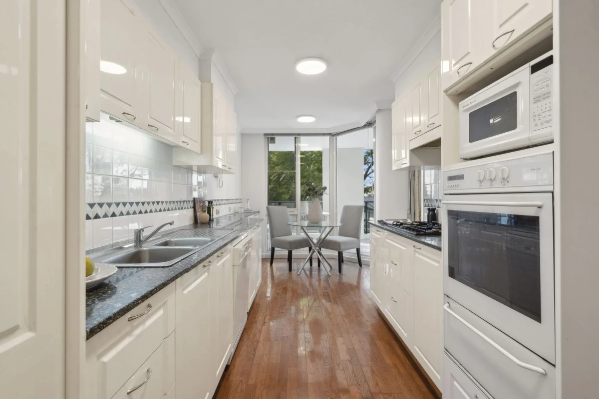 Efficient galley kitchen with ample counter space and dining nook - 5/2A Brady Street, Mosman, NSW 2088