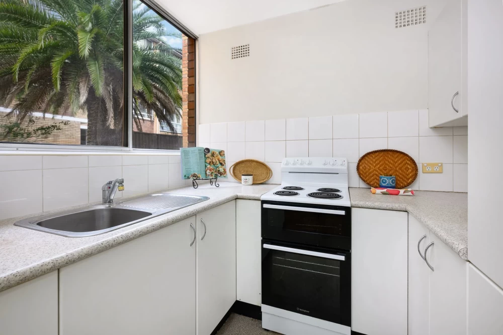 Compact kitchen with large window, countertop space, and white tiles - 5/404 Mowbray Road, Lane Cove, NSW 2066