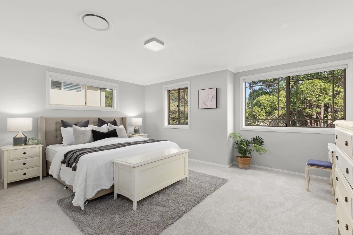 A spacious, well-lit bedroom with a large bed and ample storage - 67 Hallam Avenue, Lane Cove, NSW 2066