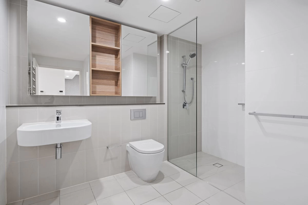 Modern bathroom with shower, large mirror, and storage space - 704/10 Waterview Drive, Lane Cove, NSW 2066