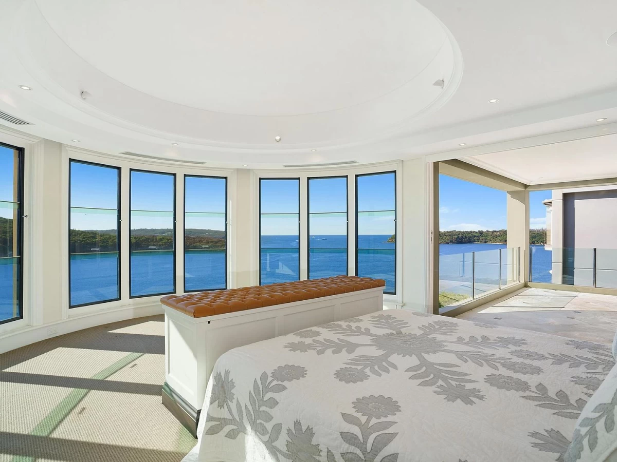 Master bedroom with a curved window wall providing sweeping ocean views - 8 Burran Avenue, Mosman, NSW 2088